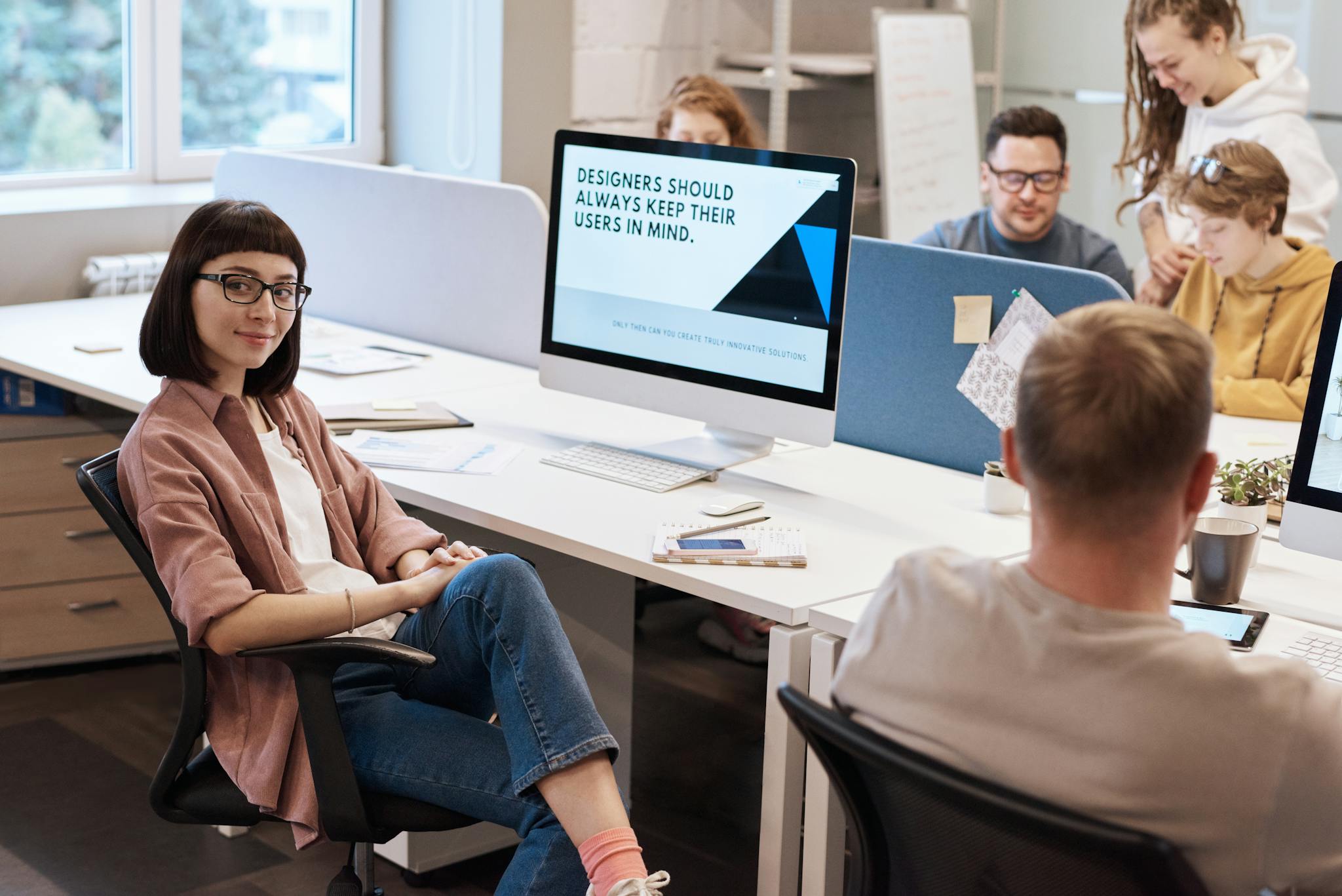 Team of young professionals collaborating in a modern office, fostering creativity and innovation.